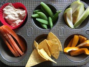 Muffin tin meal with a variety of food options