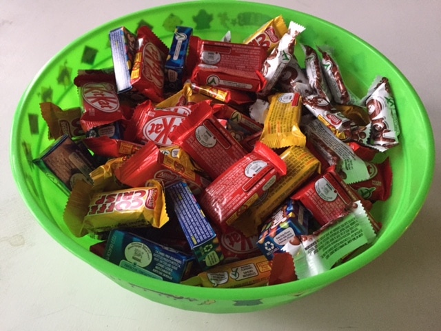 Green bowl full of extra Halloween Candy