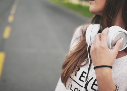 Woman with headphones around her neck