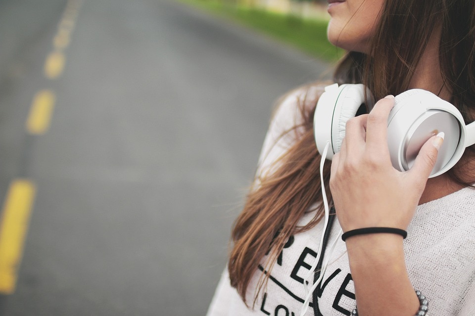 Woman with headphones around her neck