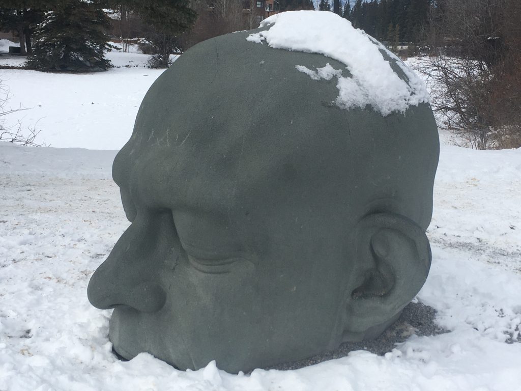 Canmore's giant grey head in winter titled "Ceannmõre."