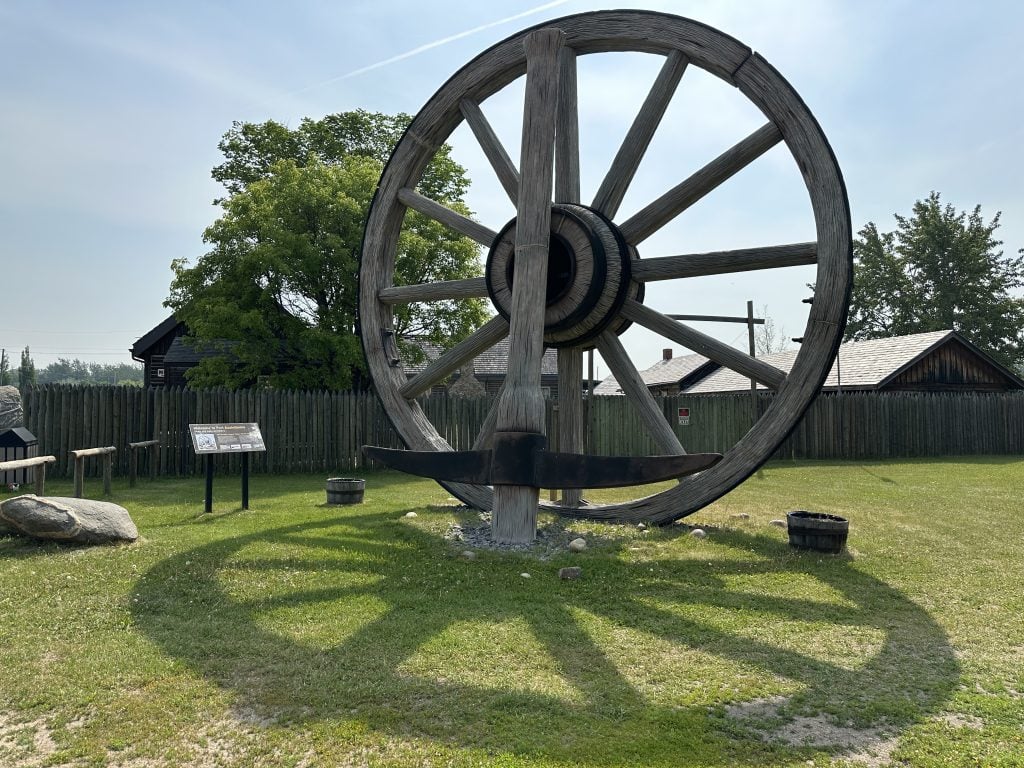 World's Largest Wagon Wheel and Pick Axe in Fort Assiniboine.