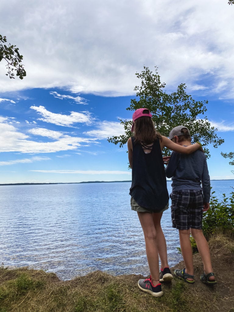 Sisters stand on the shore of Chip Lake