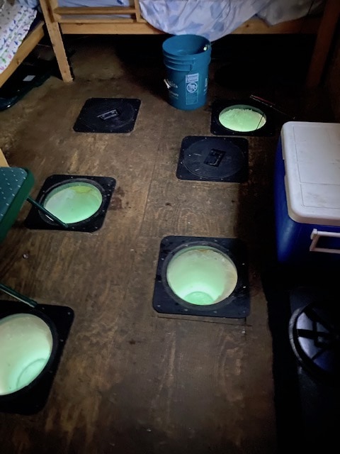 Holes in the hut floor for Ice Fishing in Alberta