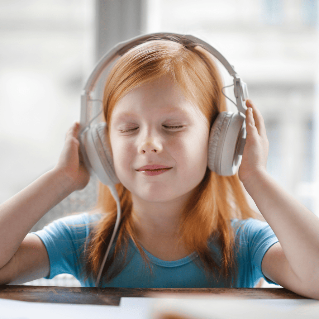 Child blissfully holding headphones on her head