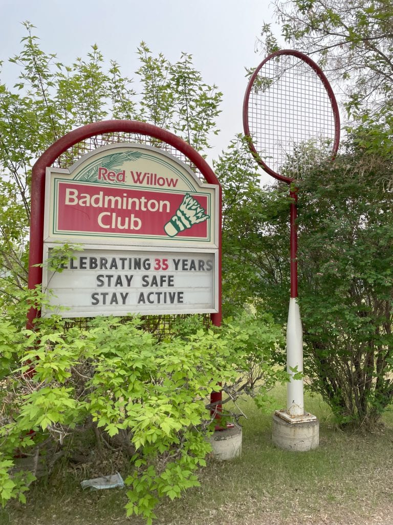 Giant badminton racket and Red Will Badminton Club sign in St Albert