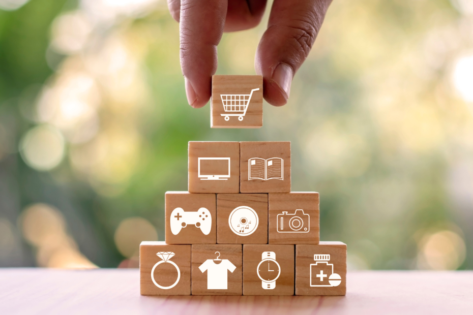 Stack of wood blocks with icons for shopping, TV, books, video games, music, photography, jewelry, clothing, a watch, and medical.